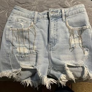 Risen Jeans size Small shorts with rhinestone embellishment on the pockets.